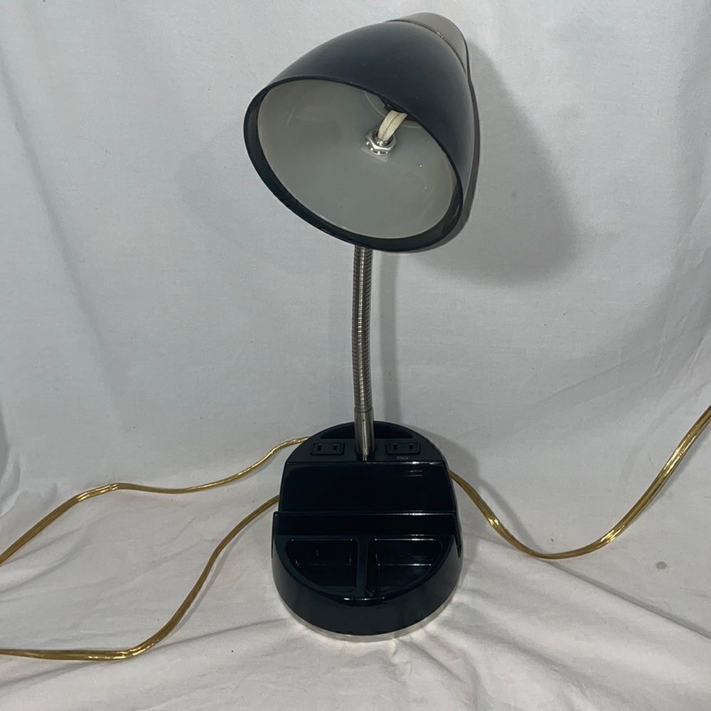Desk lamp withย outlet and slots forโofficeโsupplies